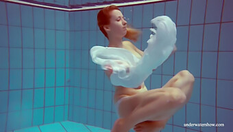 Melisa Darkova, A Fiery Redhead, Indulges In A Solo Swim In The Nude